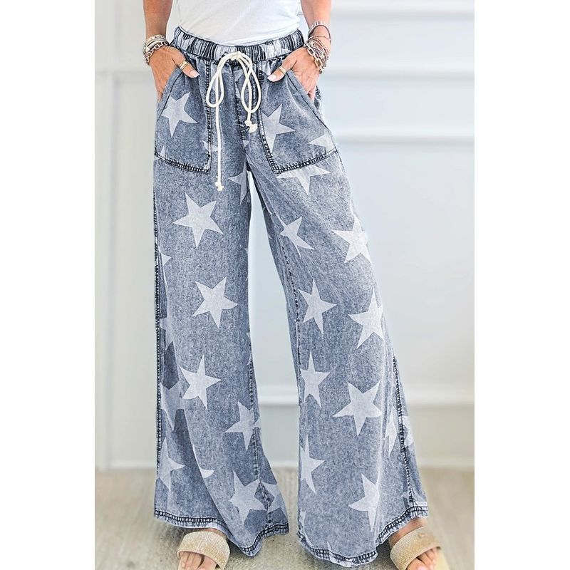Blue denim pants with star pattern worn by a person indoors.