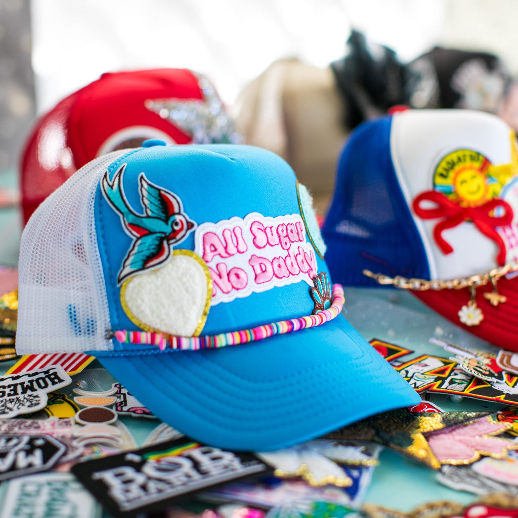 Colorful baseball cap with various stickers on a table