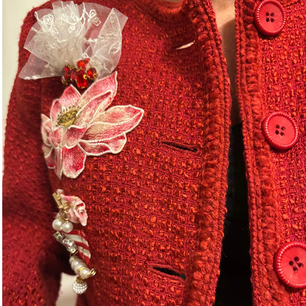 Red textured garment with floral and pearl embellishments