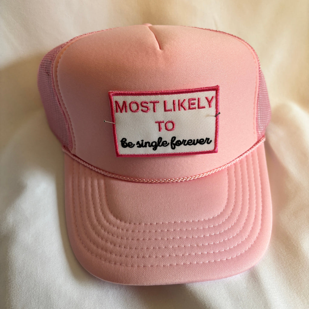 Pink cap with a patch reading 'Most Likely to be single forever' on a light background