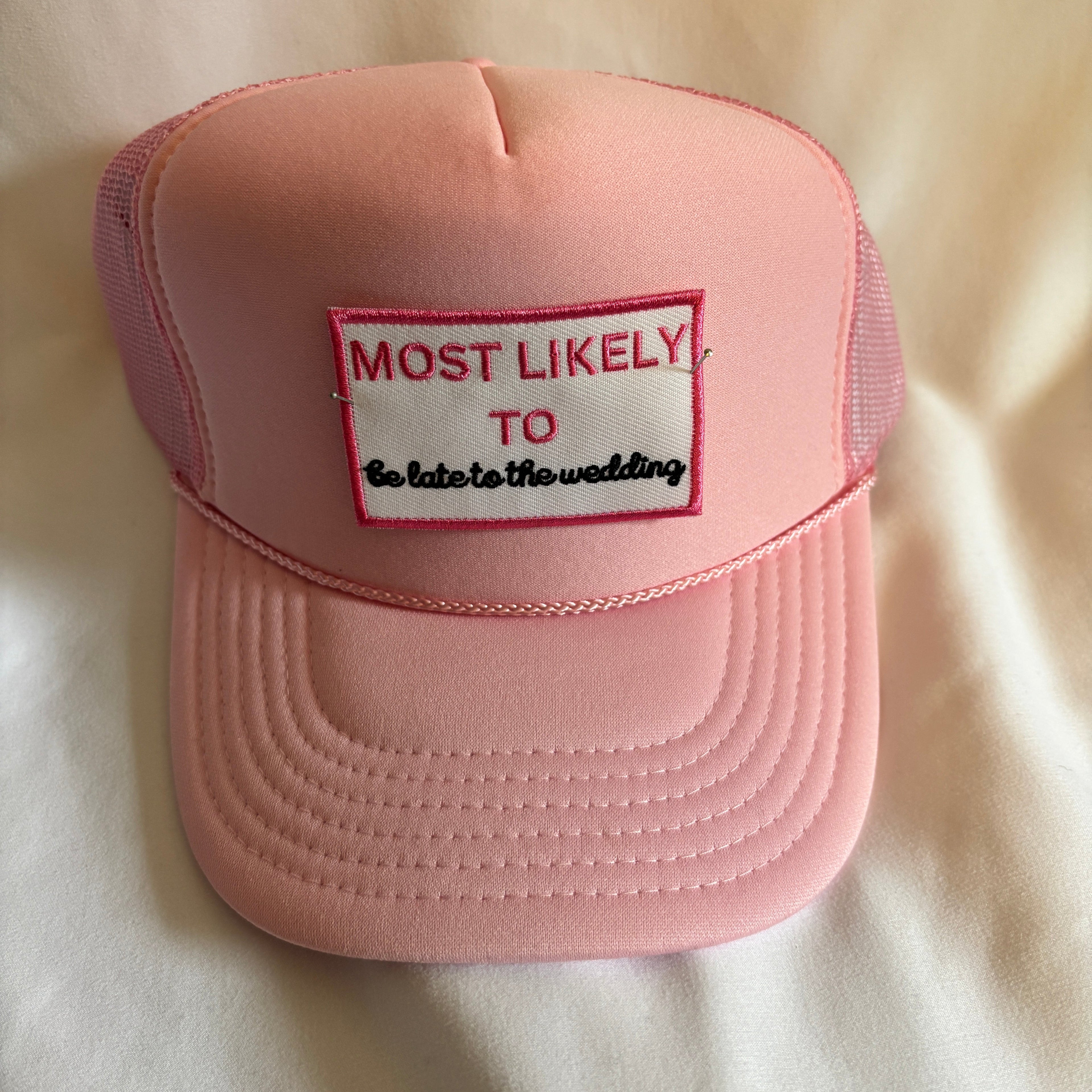 Pink cap with text on a light beige background