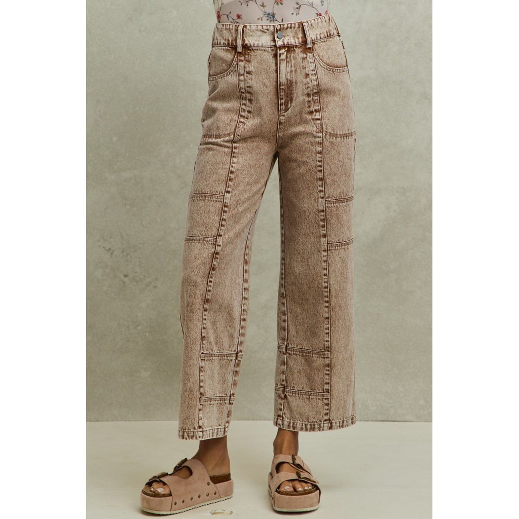 Brown wide-leg jeans worn by a person on a neutral background