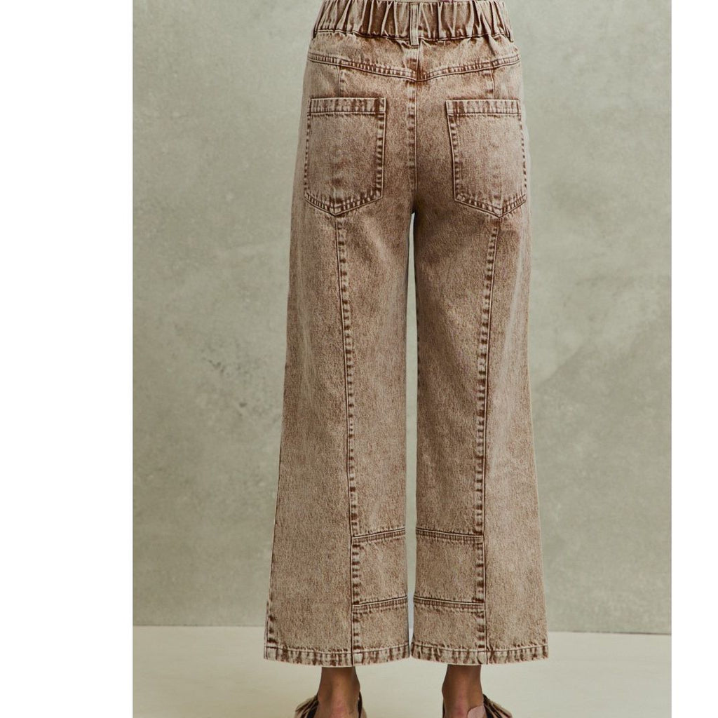 Wide-leg jeans worn by a person on a neutral background