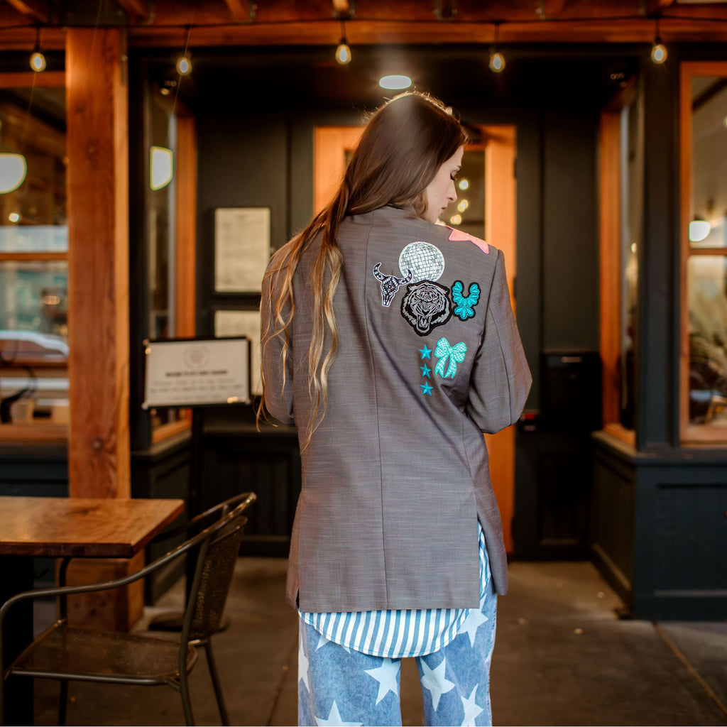 Person wearing a jacket with colorful designs in a restaurant setting